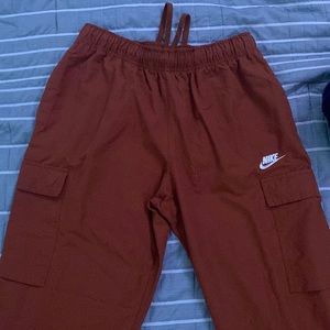 Nike pants used Size small color looks like a orange red